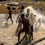 children playing in water in dharavi 2