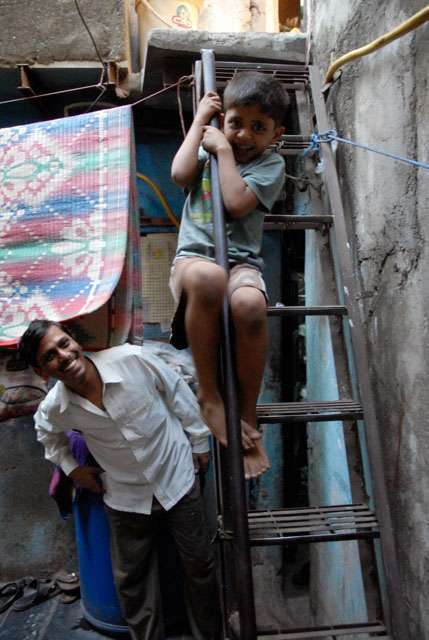 Dharavi tour: child playing on stairs