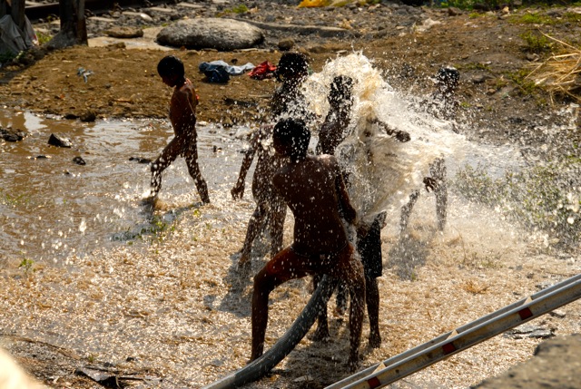 Kids playing with water in Dharavi