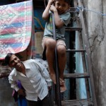 Dharavi tour: child playing on stairs