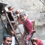Kids playing on stairs, Dharavi tour in Mumbai